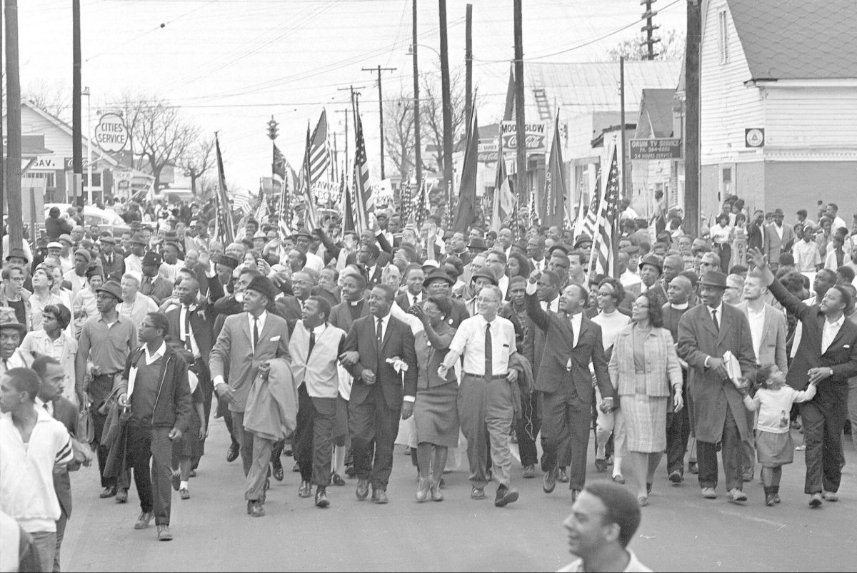 African American civil rights activists marching.