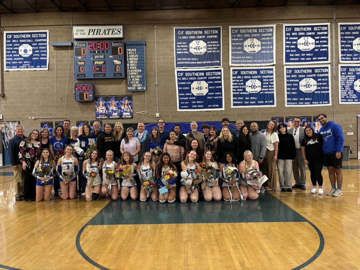 Girls Volleyball team and their parents come together for a picture after senior night.