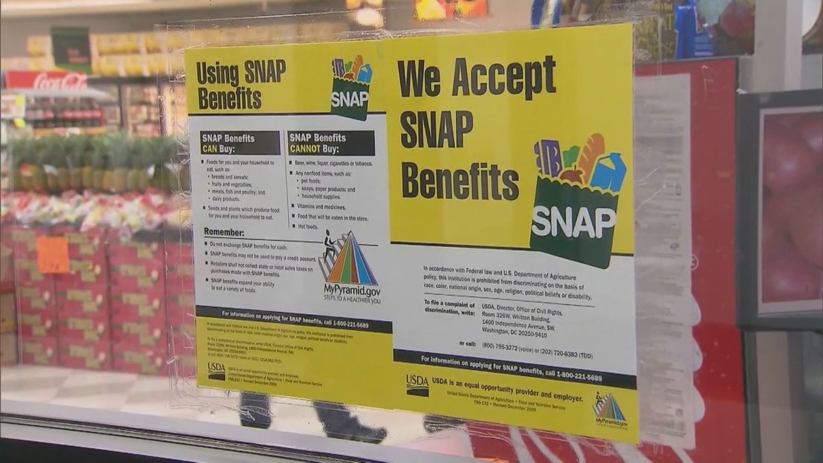A sign on a store window indicating that it accepts SNAP benefits.
