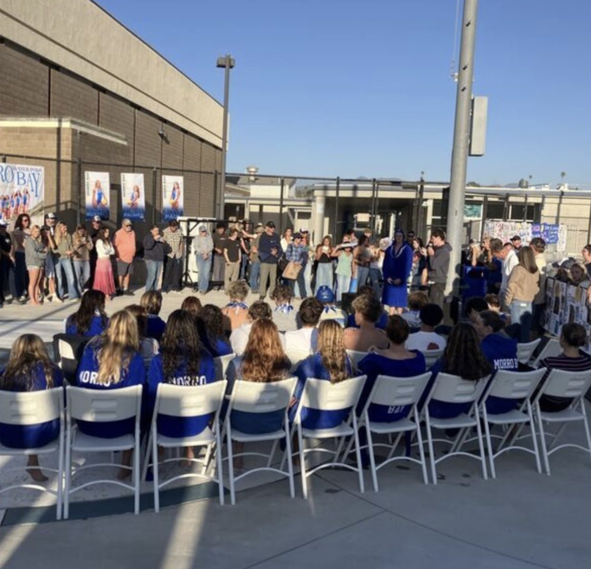 Girls and Boys water polo team waiting for senior night celebration. (Photo Credit: Scott Schalde)

