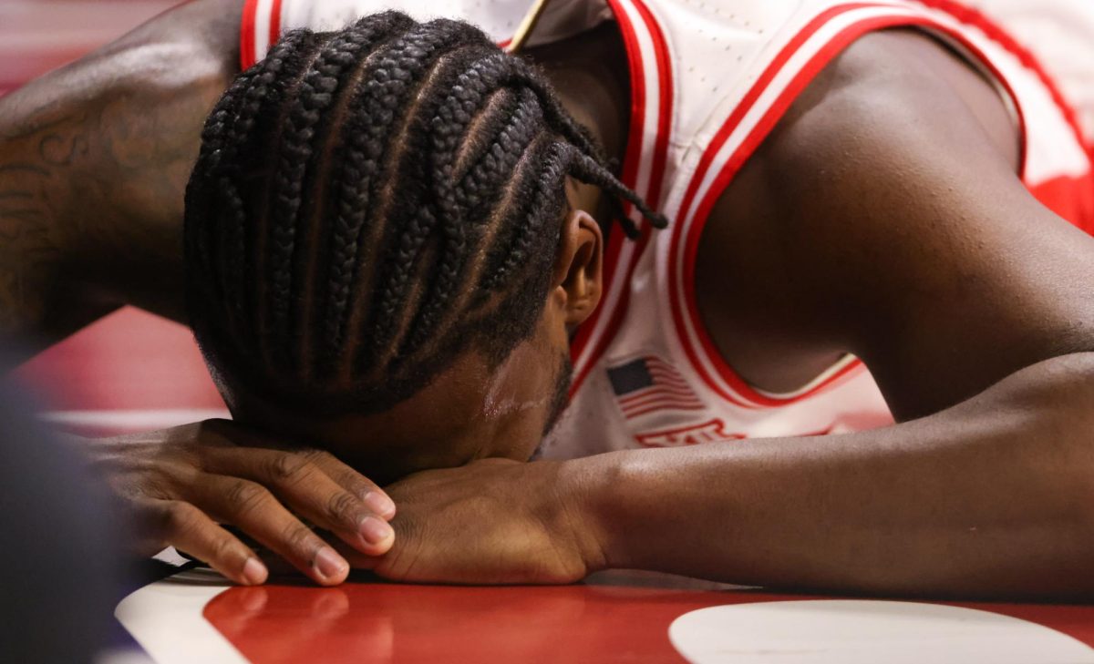 Jaden Bradley takes a moment on the floor after taking a hard foul against Kansas (Source: The Daily Wildcat)
