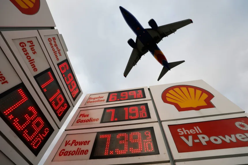 Gas prices being displayed at a Shell gas station as an airplane approaches San Diego International Airport for a landing on April 24.
[Source: Kevin Carter/Getty Images]
